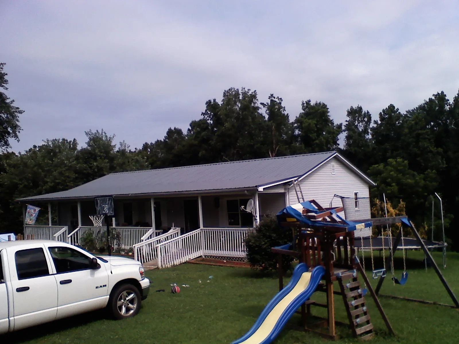 Dark metal roof on a country home with a full length front porch in Gettysburg