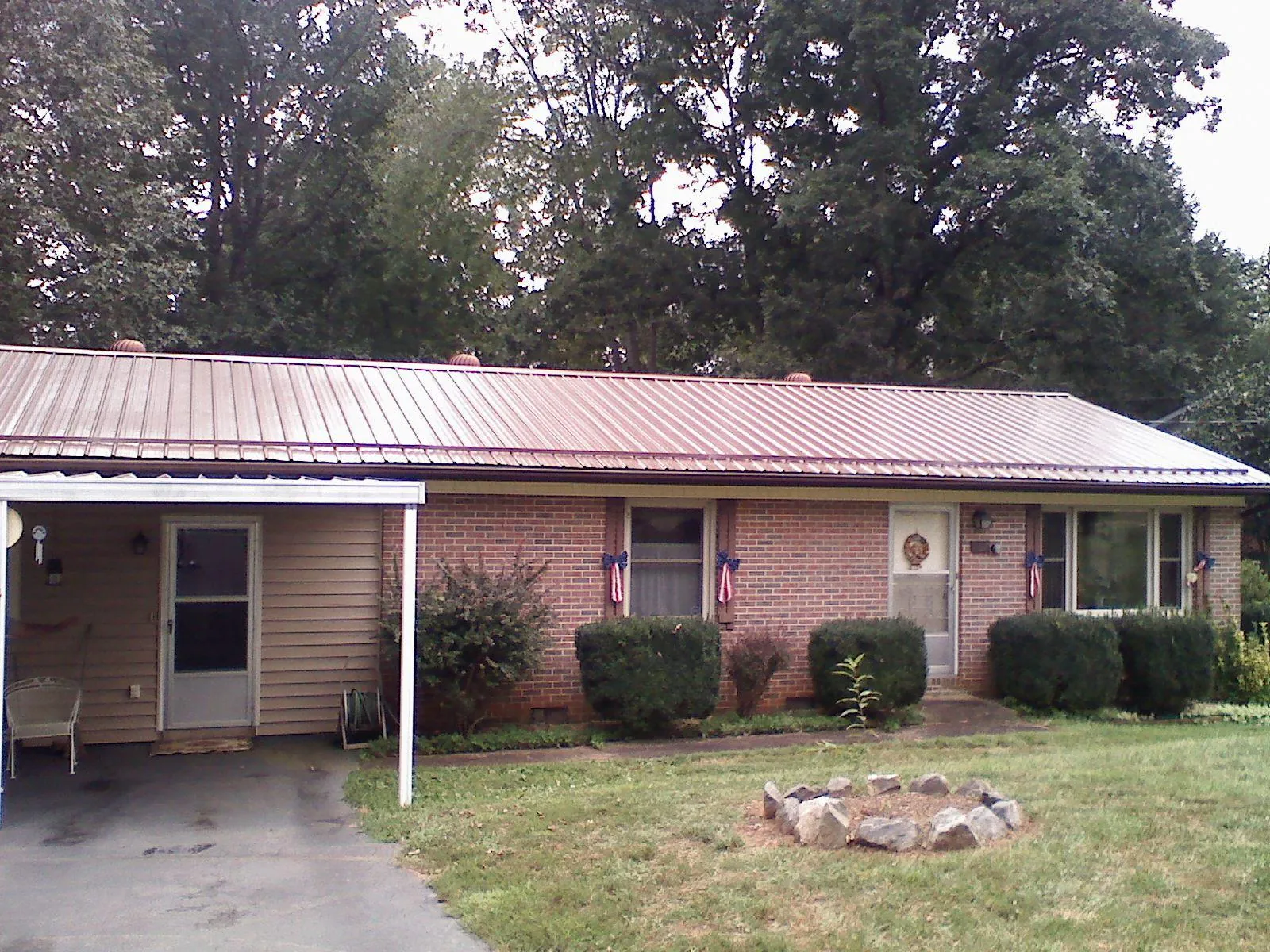 Bronze metal roof and carport on a brick ranch home — Roof Repair work by our crew in Gettysburg