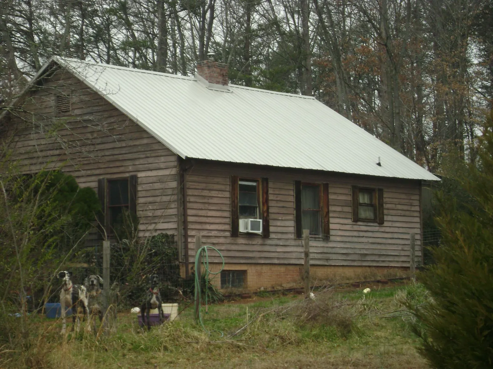 White metal roof on an old wood sided farmhouse, from a Metal Roof Installation job in Gettysburg